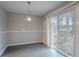 Dining area with a modern light fixture and sliding glass door at 180 Sears Cir, Covington, GA 30016