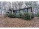 Ranch-style home with a yard covered in leaves at 180 Sears Cir, Covington, GA 30016
