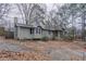 View of the home's side and front, displaying a chimney and well kept yard at 180 Sears Cir, Covington, GA 30016
