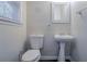 Classic half bathroom featuring a pedestal sink, toilet, and window for natural light at 180 Sears Cir, Covington, GA 30016
