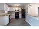 A kitchen featuring white cabinets, black appliances, and modern countertops offers a stylish and functional space at 180 Sears Cir, Covington, GA 30016