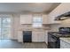 A bright kitchen with sleek appliances and ample counter space opens to a sliding glass door to the yard at 180 Sears Cir, Covington, GA 30016