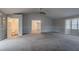 Open living room with ceiling fan, neutral paint, and views of the entry and bathroom at 180 Sears Cir, Covington, GA 30016
