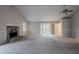 Living area featuring a ceiling fan, fireplace, and sliding glass door at 180 Sears Cir, Covington, GA 30016