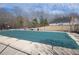 Community pool with a green cover; ready for swimming season at 2100 Bradford Pear Se Cir, Conyers, GA 30013