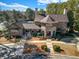 Exterior aerial view of the clubhouse with a courtyard, parking lot, and manicured landscaping at 6369 Queens Court Trce, Mableton, GA 30126