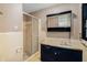Bathroom with plaid wallpaper, shower and dark vanity at 75 Azalea Trl, Carrollton, GA 30116