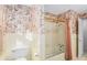 Bathroom with floral wallpaper, shower/tub combo, and vintage vanity at 75 Azalea Trl, Carrollton, GA 30116