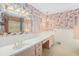 Pink bathroom with double vanity and a large mirror at 75 Azalea Trl, Carrollton, GA 30116
