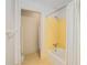 Retro bathroom with yellow tile, bathtub, and shower at 75 Azalea Trl, Carrollton, GA 30116