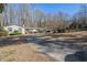 House exterior showcasing a long driveway and surrounding landscape at 75 Azalea Trl, Carrollton, GA 30116