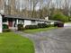 White brick ranch house with red door and landscaping at 75 Azalea Trl, Carrollton, GA 30116