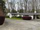 White brick ranch house with carport and landscaping at 75 Azalea Trl, Carrollton, GA 30116