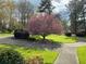 Landscaped front yard with flowering tree and circular driveway at 75 Azalea Trl, Carrollton, GA 30116