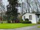 White brick ranch house with well-manicured lawn and mature trees at 75 Azalea Trl, Carrollton, GA 30116