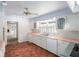 Kitchen boasts white cabinets and terracotta tile flooring at 75 Azalea Trl, Carrollton, GA 30116