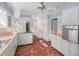 Kitchen with white cabinets, terracotta tile floor, and pink countertops at 75 Azalea Trl, Carrollton, GA 30116