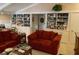 Spacious living room with built-in shelving and red couches at 75 Azalea Trl, Carrollton, GA 30116