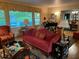 Living room features hardwood floors, red sofa, and views to dining room at 75 Azalea Trl, Carrollton, GA 30116