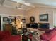 Living room with red couches, wood fireplace, and high ceiling at 75 Azalea Trl, Carrollton, GA 30116