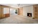 Living room with wood paneling, fireplace and sliding glass doors at 75 Azalea Trl, Carrollton, GA 30116