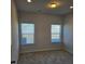 Bright bedroom with neutral walls and carpet, featuring two large windows with blinds at 1455 Weeping Tree Cir, Auburn, GA 30011