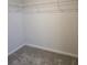 Walk-in closet with wire shelving and neutral carpeting at 1455 Weeping Tree Cir, Auburn, GA 30011