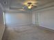 Spacious main bedroom with ceiling fan and neutral carpeting at 1455 Weeping Tree Cir, Auburn, GA 30011