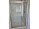 Large walk-in shower with glass enclosure and built-in shelving at 1455 Weeping Tree Cir, Auburn, GA 30011