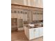Bright kitchen featuring white cabinets, gold hardware, and center island awaiting countertops at 3336 Ferncliff Ne Pl, Atlanta, GA 30324