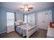 Bright bedroom with white bed frame and ceiling fan at 1039 Ola Dale Dr, Mcdonough, GA 30252