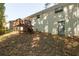 House backyard with wooden stairs leading up to a deck at 4704 Apache Sw Trl, Atlanta, GA 30331