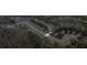 An aerial view showcasing a house and surrounding trees at 8785 Seneca Rd, Palmetto, GA 30268