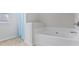 Bathroom with soaking tub and light blue shower curtain at 8785 Seneca Rd, Palmetto, GA 30268