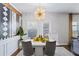 Dining area with modern light fixture and art at 8785 Seneca Rd, Palmetto, GA 30268