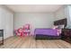 Bedroom with a purple bedspread and wood-look flooring at 365 Winding River Dr # E, Atlanta, GA 30350