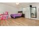 Bedroom with a purple bedspread and wood-look flooring at 365 Winding River Dr # E, Atlanta, GA 30350