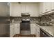 View of kitchen with stainless steel appliances and granite countertops at 365 Winding River Dr # E, Atlanta, GA 30350