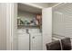 Laundry room with washer, dryer, and overhead shelving at 365 Winding River Dr # E, Atlanta, GA 30350