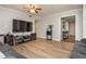 Living room features hardwood floors, large TV, and ceiling fan at 365 Winding River Dr # E, Atlanta, GA 30350