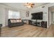 Living room with hardwood floors, large TV, and comfortable seating at 365 Winding River Dr # E, Atlanta, GA 30350