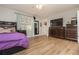 Main bedroom with a purple bedspread and wood-look flooring at 365 Winding River Dr # E, Atlanta, GA 30350