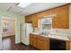 Galley kitchen with wood cabinets and white appliances at 202 Mount Glen Ct, Woodstock, GA 30188