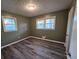Bright bedroom with wood-look floors and neutral walls at 5737 Lorraine Dr, Stone Mountain, GA 30087
