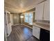 Dining area with gray flooring and a chandelier, adjacent to kitchen at 5737 Lorraine Dr, Stone Mountain, GA 30087