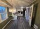 Open dining area with gray flooring, chandelier, and kitchen views at 5737 Lorraine Dr, Stone Mountain, GA 30087