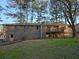 Back view of brick ranch house with deck and spacious backyard at 5737 Lorraine Dr, Stone Mountain, GA 30087