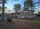 Brick ranch house with pink shutters, landscaped yard, and driveway at 5737 Lorraine Dr, Stone Mountain, GA 30087
