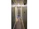 Long hallway with wood-look flooring and neutral walls at 5737 Lorraine Dr, Stone Mountain, GA 30087