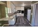 Kitchen with white cabinets, gray flooring, and access to dining area at 5737 Lorraine Dr, Stone Mountain, GA 30087